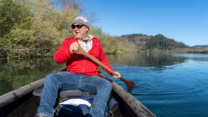 Josh Norris canoeing in a red jacket on the Klamath river