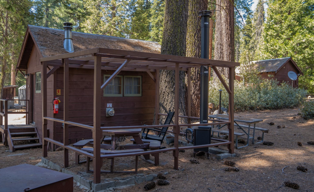 A cabin with patio seating featuring a rocking chair